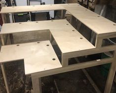 several unfinished wooden tables sitting in a room