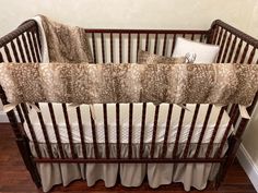 a baby crib with two pillows on top of it and a pillow in the middle