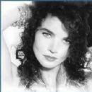 a black and white photo of a woman with curly hair