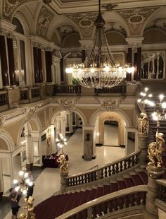 an ornate building with chandeliers and stairs