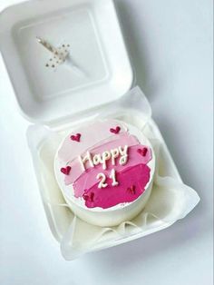 a heart shaped cake in a box with the word happy 21st on it's side