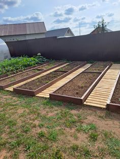 several raised garden beds in the middle of a yard