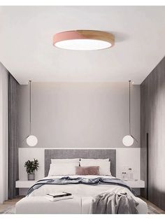 a large bed sitting under a round light fixture