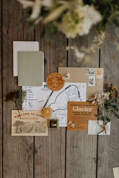 an assortment of paper and other items on a wooden surface