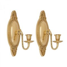 two gold wall sconces with candle holders