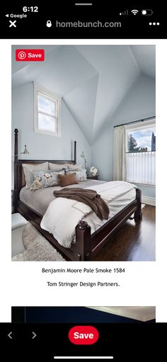 a bed room with a neatly made bed next to two windows and a window sill