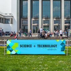 a large sign in front of a building that says science and technology exhibition on it