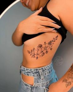 a woman with a flower tattoo on her stomach