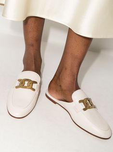 Cream leather Sabot loafer mules from TOD'S featuring gold-tone logo plaque, round toe, slip-on style, tonal stitching, branded leather insole and flat leather sole. | Tod's Sabot loafer mules Elegant Beige Flat Mules, Elegant Gold Mules For Workwear, Gold Slip-on Mules For Work, Gold Mules For Work, Elegant Flat Mules With Metal Feet, Luxury Gold Slip-on Mules, Elegant Gold Flat Mules, Luxury Slip-ons For Workwear, Chic Gold Loafers