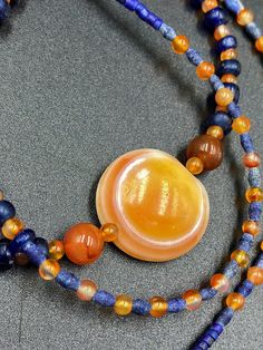 The beautiful ancient old Luk Mik or magic eye bead from Himalaya Tibet along with some blue ancient glass beads along with some orange color carnelian and lapis beads as spacers in the mala necklace Lukmik means goat's eye These ancient stones can be in Carnelian and Agate forms and are natural good condition we provide fast and free shipping service world wide Handmade Lapis Lazuli Bohemian Beads, Handmade Spiritual Amber Beads, Gems, And Cabochons, Handmade Bohemian Lapis Lazuli Beads, Czech Glass Spiritual Beads, Handmade Spiritual Lapis Lazuli Beaded Necklace, Spiritual Czech Glass Round Beads, Handmade Lapis Lazuli Beaded Necklace For Spiritual Style, Blue Carnelian Spiritual Jewelry, Spiritual Blue Carnelian Jewelry