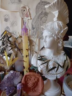 a table topped with white busturines and other decorative items on top of it