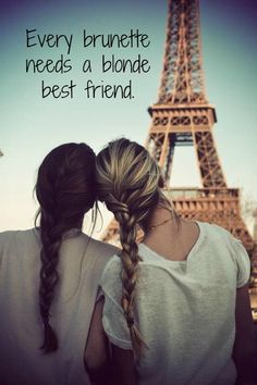 two girls standing in front of the eiffel tower with their backs to each other