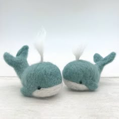 two small stuffed animals sitting next to each other