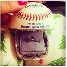 someone is holding a baseball with a ring in it's mouth and wearing a wedding band