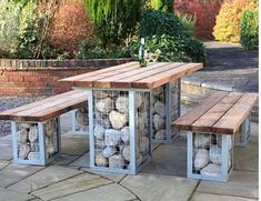 an outdoor table and bench made out of rocks