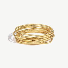 Organic shapes bend and blend in the Nyundo Stacking Bracelets. Wear for bangles that move naturally with you. This set of 7 bangle bracelets is handcrafted in 24k gold plated brass using traditional techniques. Handcrafted in gold-plated brass by artisans in Kenya. Our gold products are 24k gold-plate brass and match our brass style in color and tone. Your purchase promotes artisan innovation + entrepreneurship. To learn more about keeping your jewelry shining like new, see our Product Care Gui Innovation And Entrepreneurship, Modern Bracelets, Stacking Bracelets, Traditional Techniques, Organic Shapes, Bracelet Stack, Kenya, Bend, Bangle Bracelets