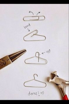 scissors and paper clips are sitting next to each other on a sheet of paper that has been drawn