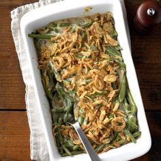 a casserole dish filled with green beans and onions