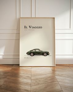 an old car is on display in front of a white wall with the words ill viago