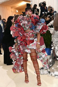 a woman in a floral dress and thigh high stockings at the mete gala event