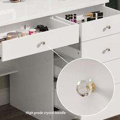 a white desk with drawers and various items in it