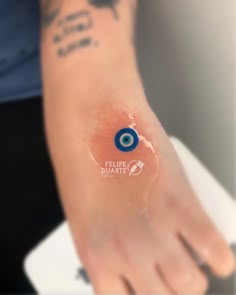 an eyeball tattoo on the arm of a person