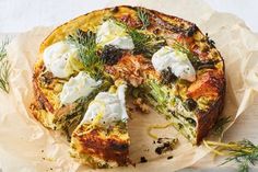 a quiche with sour cream and herbs on top