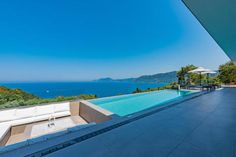 an outdoor swimming pool overlooking the ocean