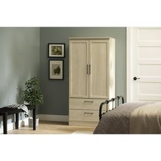 a bedroom scene with focus on the armoire and bed