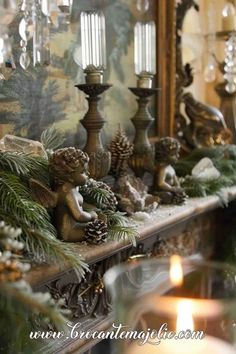 a mantle with candles and ornaments on it