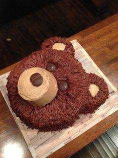 a cake shaped like a bear with chocolate eyes