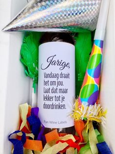 a birthday gift box filled with confetti, streamers and a party hat