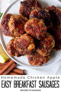 Overhead photo of a plate with about 9 round homemade breakfast sausages stacked on top of each other on the plate with cinnamon sticks and an apple wedge sitting around the plate all sitting on a white kitchen towel with text that says Homemade Chicken Apple Easy Breakfast Sausages.