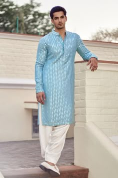 Sky blue full sleeve kurta with mirror, thread embroidery in stripe pattern. Paired with ivory salwar.
Components: 2
Pattern: Embroidery
Type Of Work: Mirror, thread
Neckline: Mandarin collar
Sleeve Type: Full sleeves
Fabric: Georgette, Lining: Cotton
Color: Blue
Other Details: 
Front button detailing
Side slit kurta
Occasion: Sangeet - Aza Fashions Indian Wedding Clothes For Men, Wedding Kurta For Men, Haldi Outfits, Wedding Dresses Men Indian, Kurta Pajama Men, Gents Kurta Design, Haldi Outfit, Gents Kurta, Blue Kurta