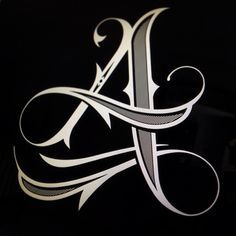 the letter a is made up of silver and black letters on a black background with white lettering