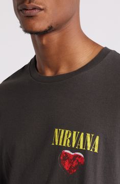 Infuse your streetwise style with '90s nostalgia in this relaxed crewneck T-shirt, featuring a Nirvana graphic that’s sure to strike a chord with your heart. Crewneck Short sleeves 100% cotton Machine wash, tumble dry Imported Band Merch Graphic Print Tops For Skateboarding, Crew Neck Top With Text Print For Music Festivals, Crew Neck Text Print Top For Music Festivals, Casual Logo Print T-shirt For Music Festivals, Casual T-shirt With Logo For Music Festivals, Acid Wash Crew Neck Top For Streetwear, Washed Black Crew Neck T-shirt For Concerts, Urban Crew Neck Tops For Skateboarding, Front Print Crew Neck Top For Music Festivals