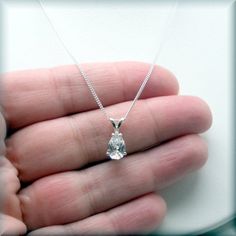 This sparkling pear shaped CZ pendant is a true stunner! Unusual shape and simple design. Cubic zirconia is a diamond alternative - wonderful for everyday wear and still get the sparkle without the cost. April's birthstone is a diamond and this would make a beautiful birthstone necklace. The pear shaped CZ pendant is 9x6 mm in size. Sterling silver setting and chain in your choice of length (see dropdown for options). Cubic zirconia is a synthesized (man-made) crystalline material that is hard a Manchester Nh, Silver Wedding Jewelry, Diamond Alternatives, April Birthstone, Cz Necklace, Jewelry Bridal, Cz Pendant, Necklace Sterling Silver, Birthstone Necklace