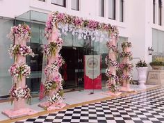 an entrance decorated with pink and white flowers