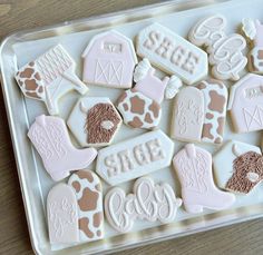 decorated cookies in the shape of farm animals are on a tray, ready to be eaten