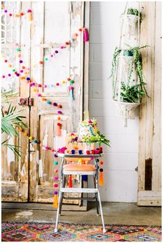 a table with a cake sitting on top of it in front of a wooden door