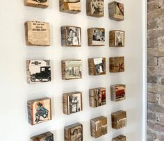 several wooden blocks are arranged on a wall with old photos and pictures attached to them