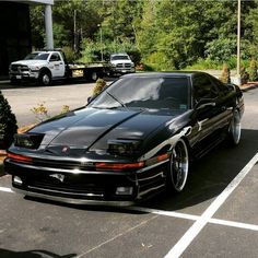 a black sports car parked in a parking lot