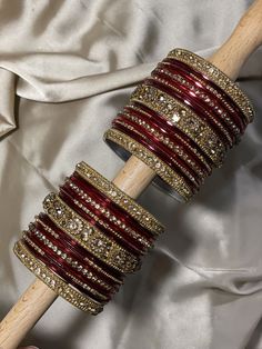 a close up of a wooden stick with bracelets on it