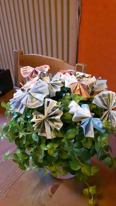 a vase filled with money sitting on top of a wooden table