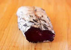 a piece of meat sitting on top of a wooden table