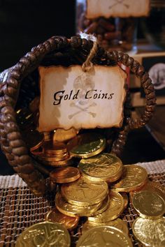 a basket filled with gold coins sitting on top of a table