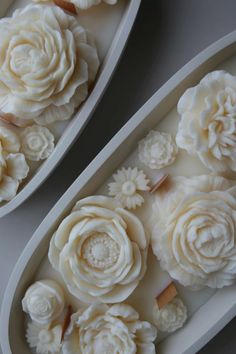 two oval trays with flowers on them