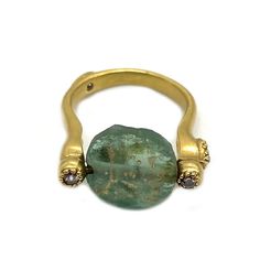 a gold ring with a green stone on it