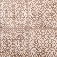 an intricately designed tile pattern on the outside of a building, with white and brown colors