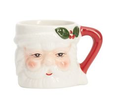 a ceramic mug with a santa face and holly berries on it's head is shown in front of a white background